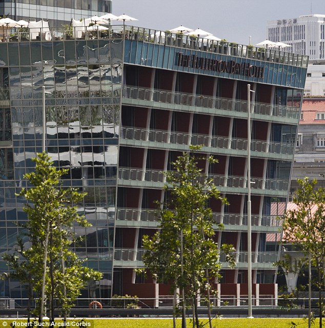 William Hart climbed over the metal railings of the Lantern bar, on top of the Fullerton Bay Hotel (pictured), and announced he could 'make the jump' to the waters below